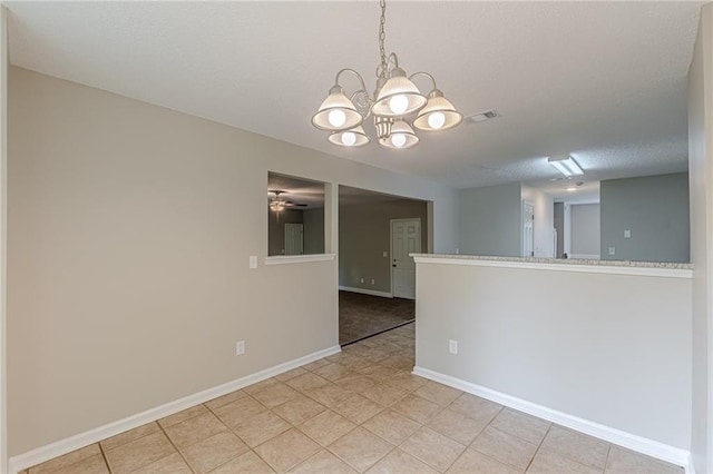 105 Kentwood Springs Dr, Hampton, GA 30228 - empty room with an inviting chandelier, light tile patterned floors, a textured ceiling, visible vents, and baseboards