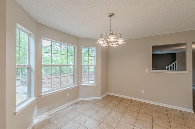 105 Kentwood Springs Dr, Hampton, GA 30228 - unfurnished dining area with a textured ceiling, a notable chandelier, light tile patterned floors, and plenty of natural light