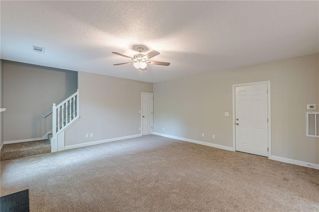 105 Kentwood Springs Dr, Hampton, GA 30228 - spare room featuring carpet flooring, visible vents, baseboards, ceiling fan, and stairs