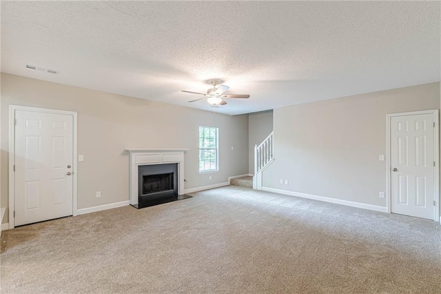 105 Kentwood Springs Dr, Hampton, GA 30228 - unfurnished living room with a textured ceiling, carpet floors, ceiling fan, and stairs