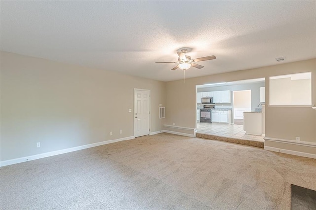 105 Kentwood Springs Dr, Hampton, GA 30228 - unfurnished living room with light colored carpet, a textured ceiling, baseboards, and a ceiling fan