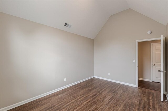 105 Kentwood Springs Dr, Hampton, GA 30228 - empty room with dark wood-style flooring, lofted ceiling, baseboards, and visible vents