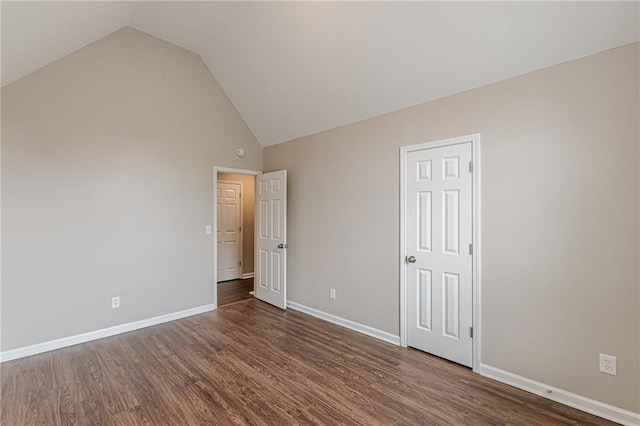 105 Kentwood Springs Dr, Hampton, GA 30228 - unfurnished bedroom with baseboards, high vaulted ceiling, and wood finished floors