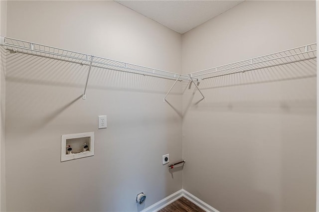 105 Kentwood Springs Dr, Hampton, GA 30228 - laundry room featuring baseboards, hookup for a washing machine, dark wood-type flooring, hookup for an electric dryer, and laundry area