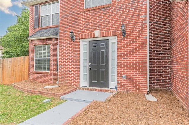 105 Kentwood Springs Dr, Hampton, GA 30228 - view of exterior entry featuring fence and brick siding