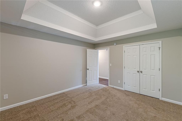 105 Kentwood Springs Dr, Hampton, GA 30228 - unfurnished bedroom with a tray ceiling, carpet flooring, baseboards, and a closet
