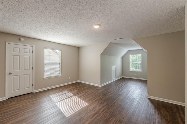 105 Kentwood Springs Dr, Hampton, GA 30228 - bonus room featuring a textured ceiling, dark wood-type flooring, baseboards, and visible vents