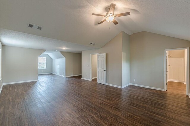 105 Kentwood Springs Dr, Hampton, GA 30228 - additional living space featuring a textured ceiling, vaulted ceiling, ceiling fan, and dark wood-style floors