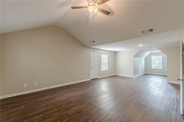 105 Kentwood Springs Dr, Hampton, GA 30228 - additional living space featuring visible vents, lofted ceiling, ceiling fan, and dark wood-style floors