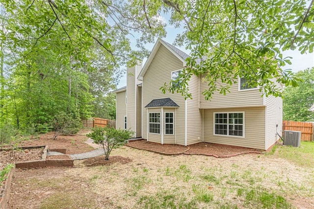 105 Kentwood Springs Dr, Hampton, GA 30228 - back of house with cooling unit, a chimney, and fence