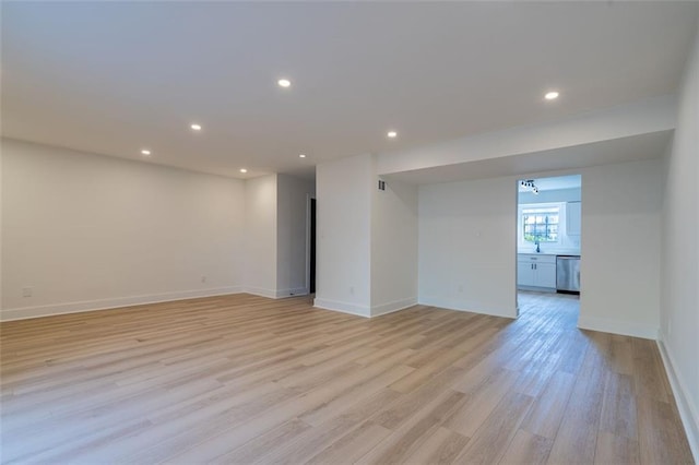 interior space with baseboards, light wood-type flooring, and recessed lighting