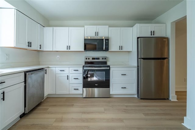 kitchen featuring light wood-style floors, light countertops, white cabinetry, and stainless steel appliances