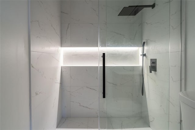 bathroom with a marble finish shower