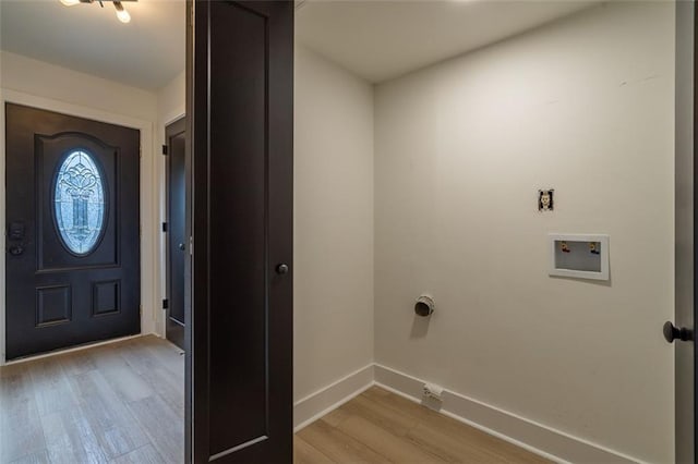 clothes washing area featuring light wood-style floors, baseboards, laundry area, and hookup for a washing machine