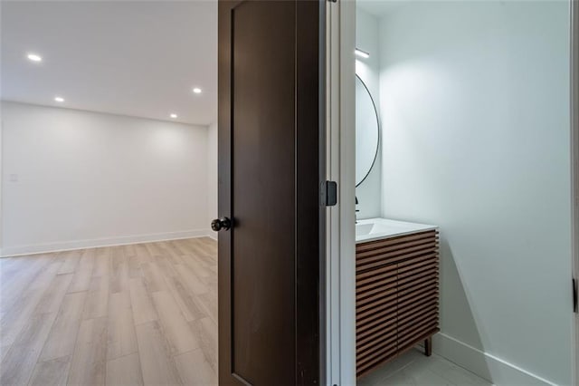 bathroom featuring recessed lighting, baseboards, and wood finished floors