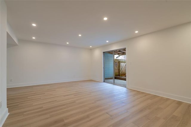 empty room with recessed lighting, light wood-style flooring, and baseboards