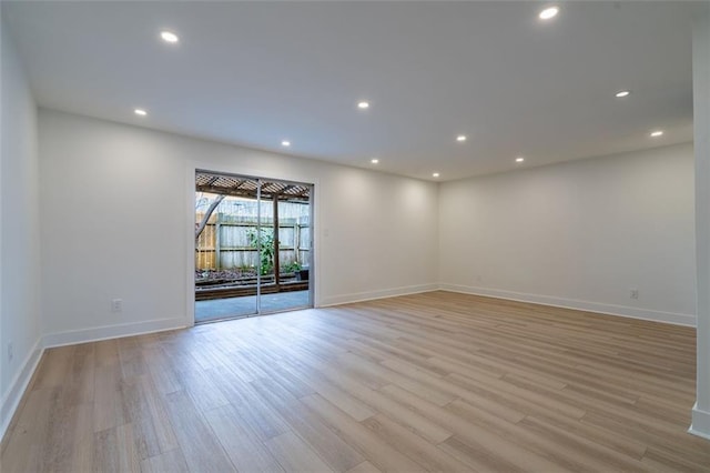 spare room featuring light wood-style floors, baseboards, and recessed lighting