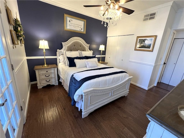 bedroom featuring dark hardwood / wood-style flooring, a closet, ceiling fan, and ornamental molding