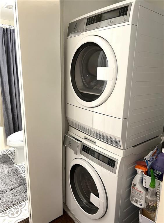 washroom featuring stacked washer and dryer