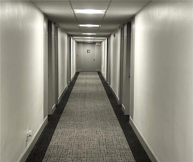 hallway with dark colored carpet