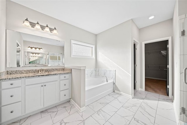 bathroom with vanity and a bath