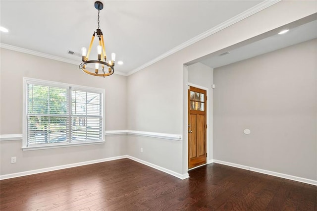 spare room with an inviting chandelier, crown molding, and dark hardwood / wood-style floors