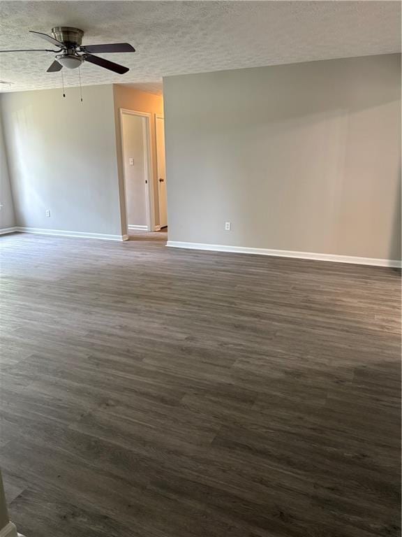 6103 Chaseland Dr, Rex, GA 30273 - spare room featuring a ceiling fan, dark wood finished floors, baseboards, and a textured ceiling