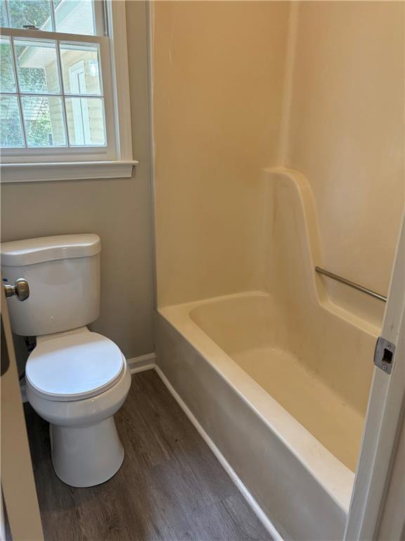 6103 Chaseland Dr, Rex, GA 30273 - full bath with wood finished floors, baseboards, toilet, and shower / bath combination