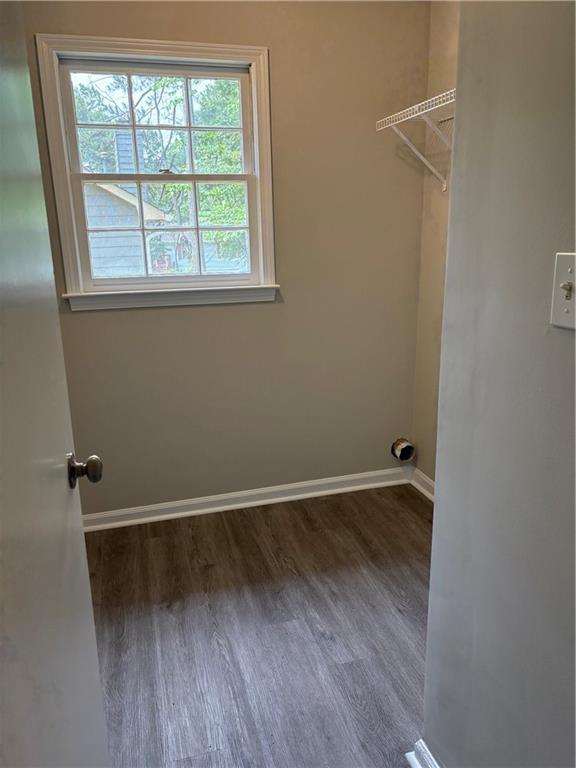 6103 Chaseland Dr, Rex, GA 30273 - washroom with healthy amount of natural light, wood finished floors, and baseboards
