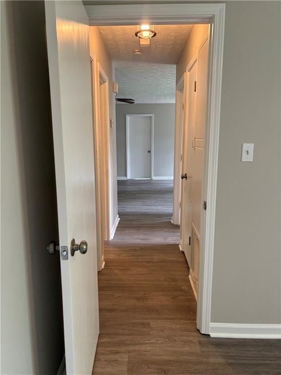 6103 Chaseland Dr, Rex, GA 30273 - hallway with baseboards and dark wood-type flooring
