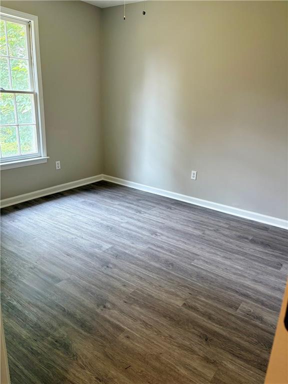 6103 Chaseland Dr, Rex, GA 30273 - spare room with dark wood-style floors and baseboards