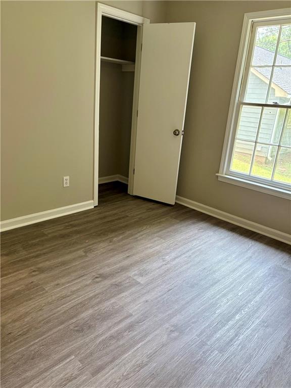 6103 Chaseland Dr, Rex, GA 30273 - unfurnished bedroom featuring baseboards, wood finished floors, and a closet