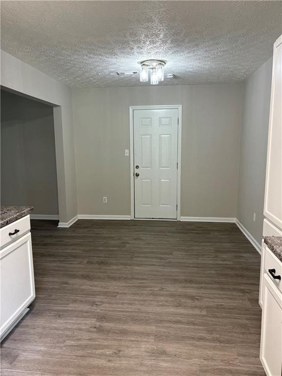 6103 Chaseland Dr, Rex, GA 30273 - entryway featuring a textured ceiling, baseboards, and dark wood finished floors