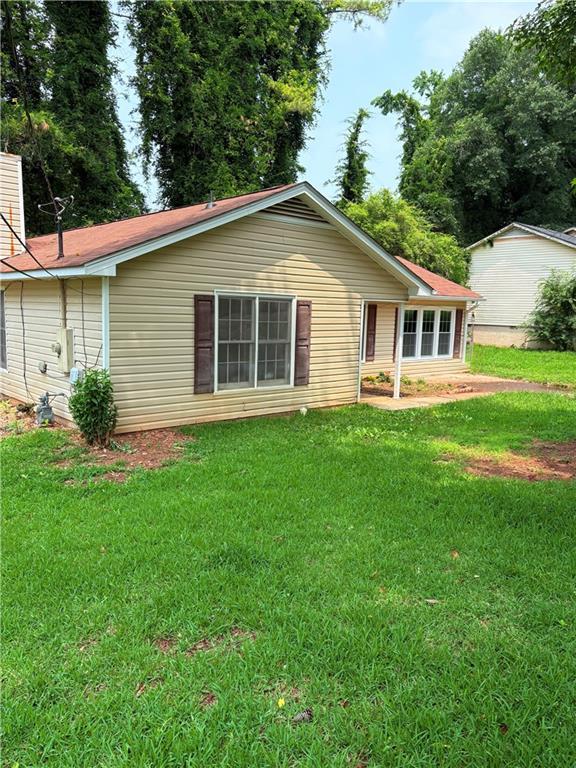 6103 Chaseland Dr, Rex, GA 30273 - back of house with a lawn and a chimney