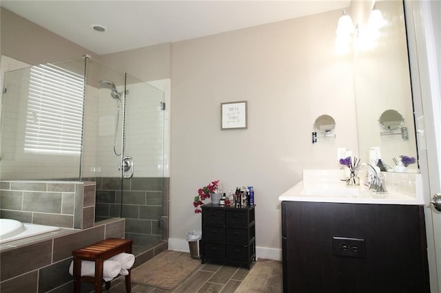 1976 Boyd Trace Ln NW, Atlanta, GA 30318 - bathroom featuring a shower stall, vanity, a garden tub, wood finished floors, and baseboards