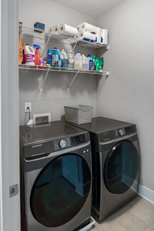 1976 Boyd Trace Ln NW, Atlanta, GA 30318 - washroom featuring washer and clothes dryer, light tile patterned floors, and baseboards