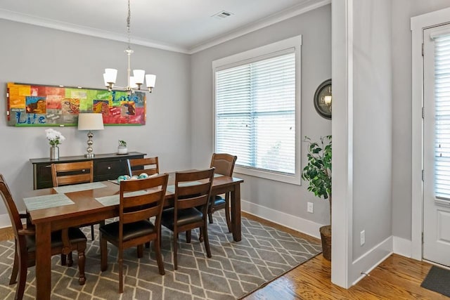 1976 Boyd Trace Ln NW, Atlanta, GA 30318 - dining area with a chandelier, ornamental molding, healthy amount of natural light, baseboards, and wood finished floors