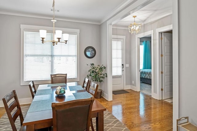 1976 Boyd Trace Ln NW, Atlanta, GA 30318 - dining room with a chandelier, wood finished floors, healthy amount of natural light, crown molding, and baseboards