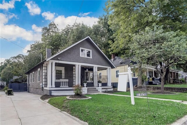 bungalow-style home featuring covered porch and central AC unit