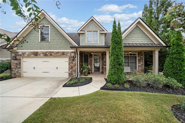 craftsman house featuring a front yard and a garage