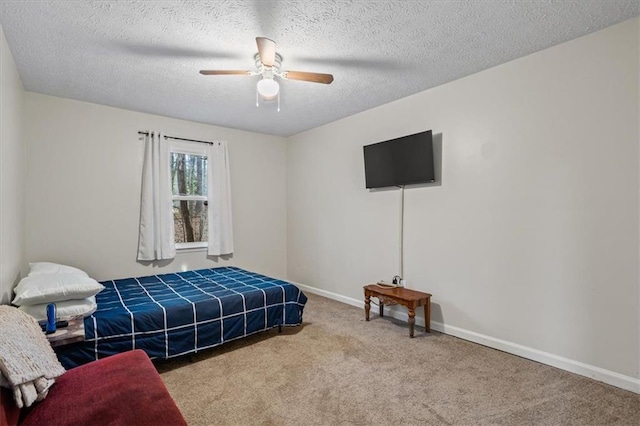 carpeted bedroom with ceiling fan and a textured ceiling