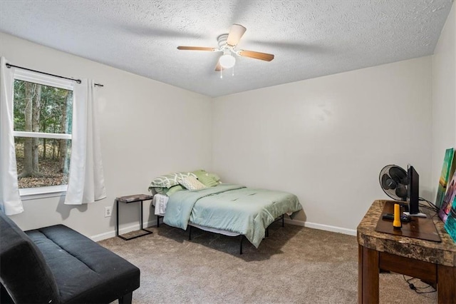 carpeted bedroom with ceiling fan and a textured ceiling