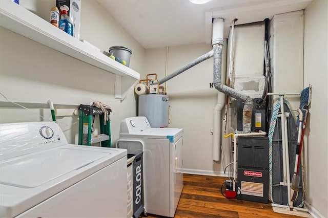 washroom with water heater, dark hardwood / wood-style flooring, and washer and clothes dryer