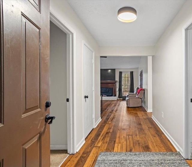 corridor with hardwood / wood-style flooring