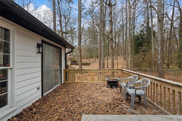 wooden deck with an outdoor fire pit