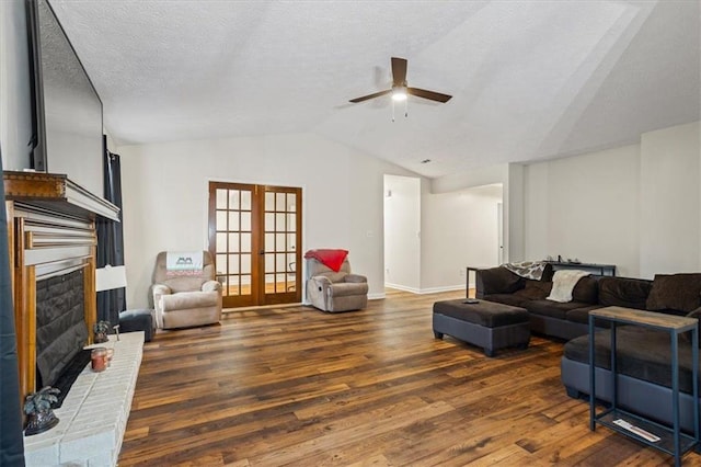 living room with french doors, a fireplace, dark wood-type flooring, and vaulted ceiling