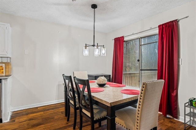 dining area featuring dark hardwood / wood-style flooring and a textured ceiling