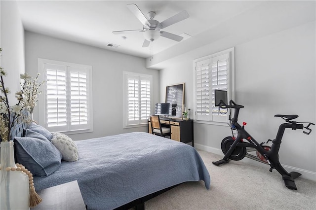 carpeted bedroom with a ceiling fan, visible vents, and baseboards