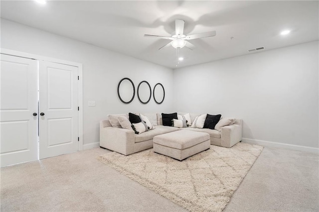 carpeted living area featuring baseboards, visible vents, a ceiling fan, and recessed lighting