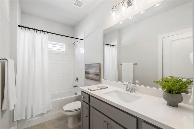 full bathroom with shower / bath combo, visible vents, vanity, and toilet